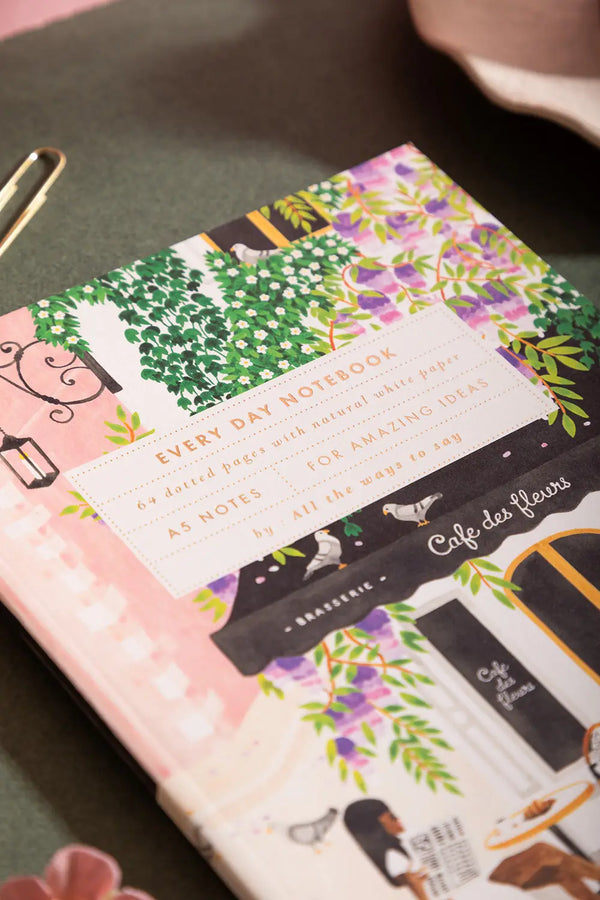 Notebook A5 Paris - Close-up of the gold foil title and hand-painted floral Parisian scene.