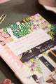 Notebook A5 Paris - Close-up of the gold foil title and hand-painted floral Parisian scene.