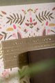 Pink Croco Notebook A5 - Close-up of the gold foil title plate and hand-painted floral patterns.