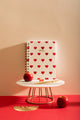 Heart Notebook Spiral - Front view on a marble stand with a red apple and gold accessories.