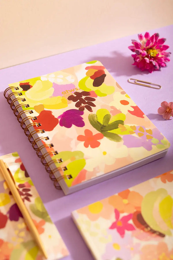 Spring Sweets Spiral Notebook - Front view on a lilac background with golden office accessories.