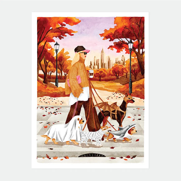 Illustrated poster of a woman walking four dogs dressed in Halloween costumes, a ghost, a mummy, a shark, and a bat, through an autumn park with a city skyline in the background, October Walks poster by All The Ways To Say