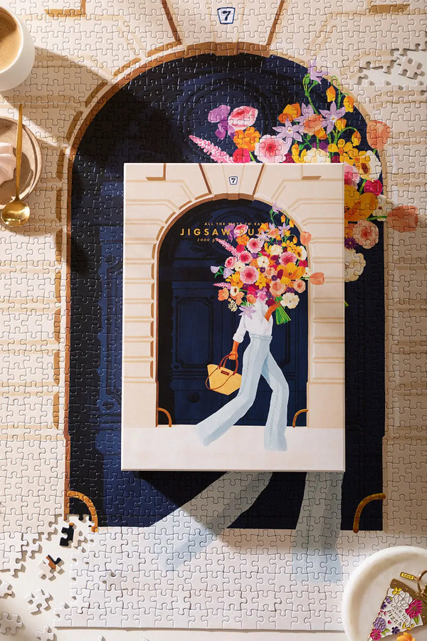 Parisian Door - Puzzle 1000 pieces: the illustrated product box placed directly over the completed 1000-piece puzzle.