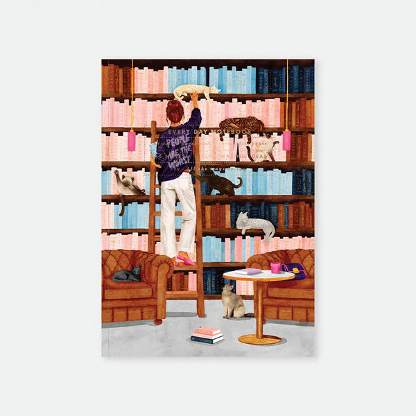 People Are The Worst A5 notebook cover by All The Ways To Say, illustration of a woman on a library ladder reaching for a cat, her sweater reading "People are the worst," surrounded by floor-to-ceiling bookshelves with several cats lounging among the books and armchairs