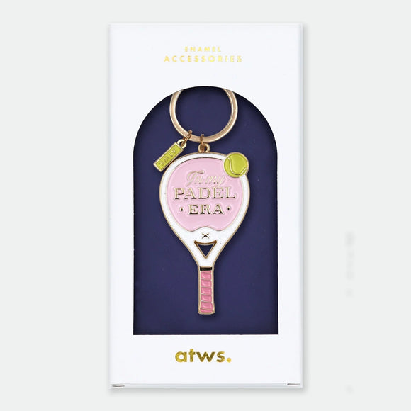 Enamel and metal keychain shaped like a pink and white padel racket with a yellow tennis ball, text reading "In my padel era," gold-tone ring and "ATWS" charm