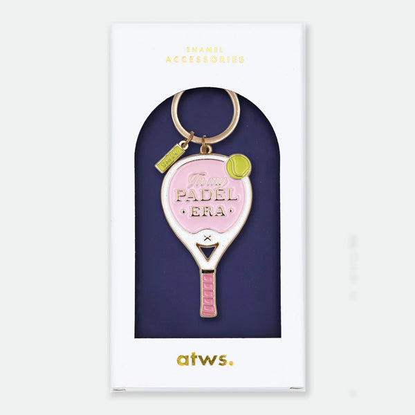 Enamel and metal keychain shaped like a pink and white padel racket with a yellow tennis ball, text reading "In my padel era," gold-tone ring and "ATWS" charm