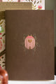 Pink Croco Pocket Notebook A6 DUO - Full front view of the brown notebook with gold beetle emblem.