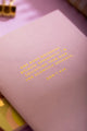 Spring Sweets Pocket Notebook A6 DUO - Detailed view of the golden quote on the purple cover.