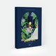 Swing paint by numbers kit box by All The Ways To Say, illustration of a woman in a straw hat seen from behind on a swing surrounded by dense tropical jungle foliage in an arched frame, "paint art. The Paint By Number Kit by All The Ways To Say"