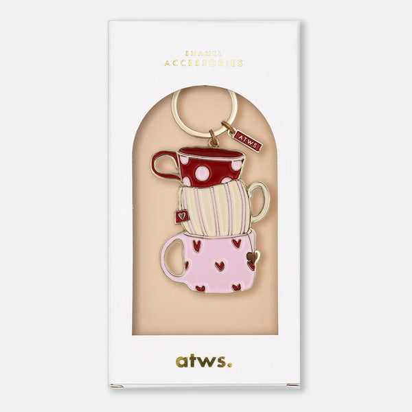 Enamel and metal keychain of three stacked teacups in red polka dot, cream stripe, and pink heart patterns, gold-tone ring and "ATWS" charm