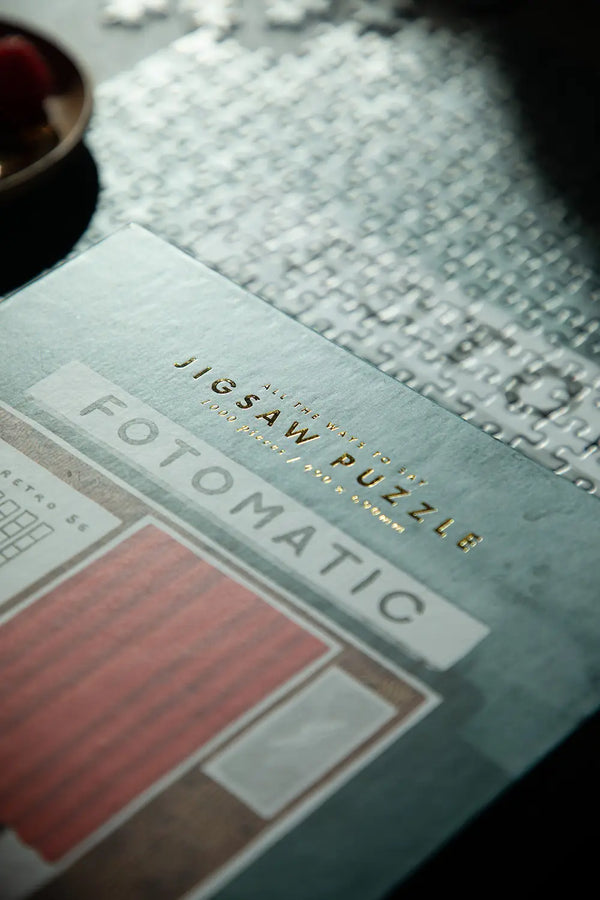Fotomatic - Puzzle 1000 pieces: elegant gold foil lettering on the premium puzzle box.