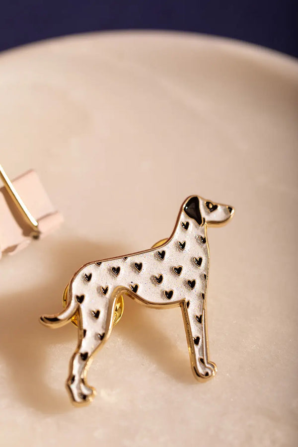 Dalmatian - Pins: Close-up of a white enamel dalmatian pin with small black heart spots.