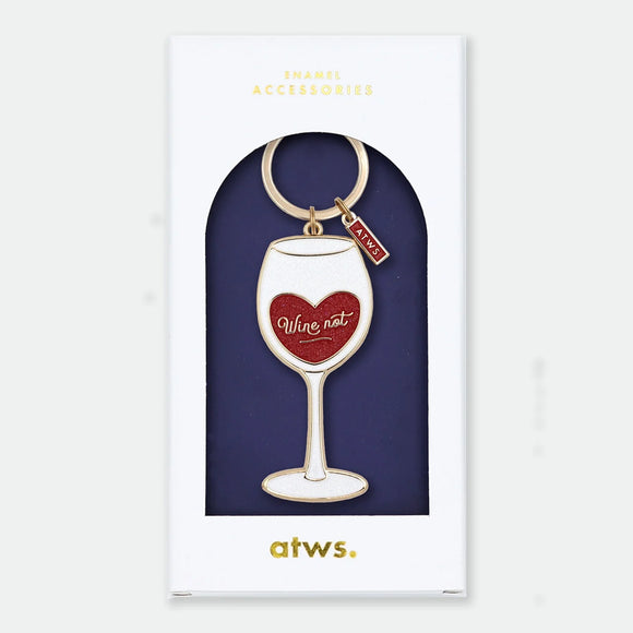 Enamel and metal keychain shaped like a wine glass with a red glittery heart inside reading "Wine not," gold-tone ring and "ATWS" charm