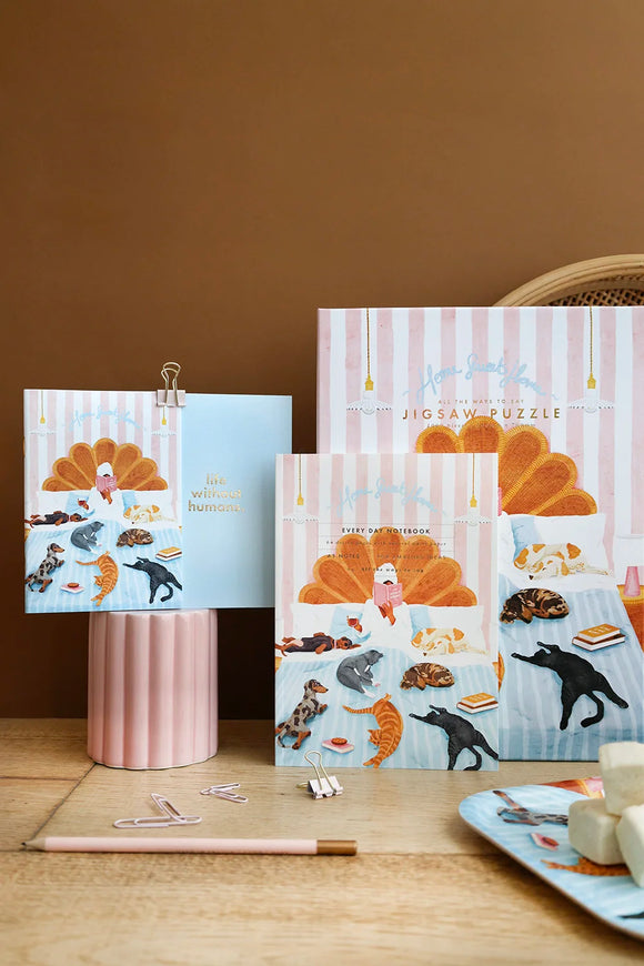 Home Sweet Home notebook and puzzle displayed with pastel accessories and illustrated cats and dogs